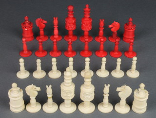 A 19th Century carved and stained ivory chess set with floral decoration, the King 3 1/2"