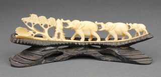 A carved ivory group of 3 elephants 8" on a hardwood base