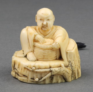 A 19th Century Japanese carved ivory Netsuke in the form of a seated man with a basket before him 1" 