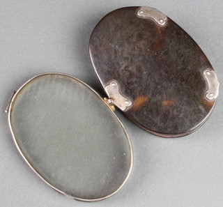 A silver mounted tortoiseshell oval magnifying glass 