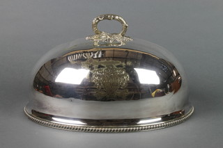 A silver plated meat cover with chased armorial 