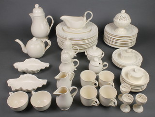 A Leedsware Classical Creamware part tea coffee and dinner service with rope twist handles and pierced geometric decoration comprising 4 coffee cups, 2 tea cups, 6 saucers, a teapot, a coffee pot, 2 cream jugs, 3 egg cups, 2 shell dishes, a sauce boat and stand, 3 lidded pots, 2 baluster shakers, a pedestal bowl with pierced lid, a lidded preserve pot, 6 small plates, 12 medium plates and 11 large plates 