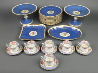 A Spode part dessert service comprising 2 tazzas, 2 shaped dishes and 11 plates, the blue and gilt ground with panels of urns of flowers and a Paragon part coffee set comprising 6 cups and 6 saucers 