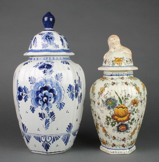 A Delft blue and white pottery vase and cover of panelled form the base marked Delft 16" (lid f and r) together a similar octagonal vase and cover  14" 