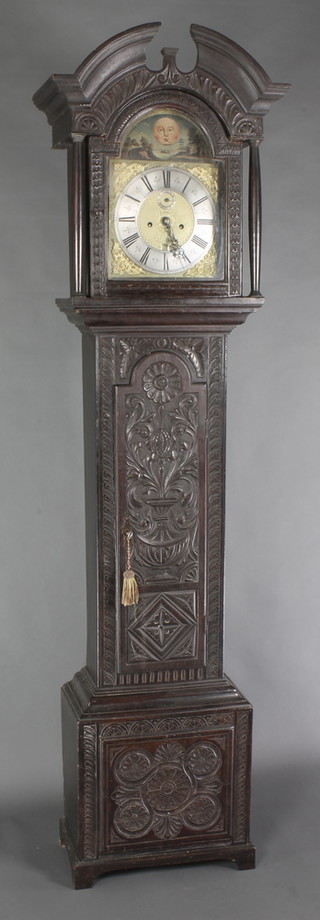 William Tipling, an 18th Century 8 day striking longcase clock, the 11" brass arch shaped dial painted moon and landscape, with silvered dial, Roman numerals, subsidiary second hand and calendar aperture, the dial marked William Tipling  Leeds Fecit, contained in a later associated carved oak case 86"h 
