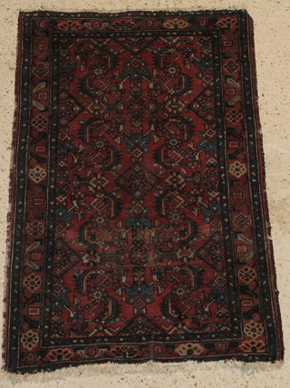 A red and blue ground Persian rug with geometric designs 48" x 30" 