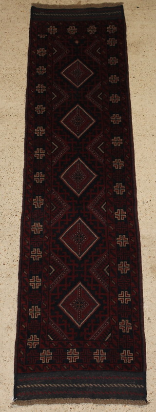 A blue and red ground Meshwani runner with 5 octagons to the centre 98" x 24"