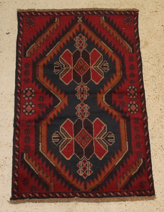 A contemporary red and tan ground Persian Belochi rug 55" x 33" 