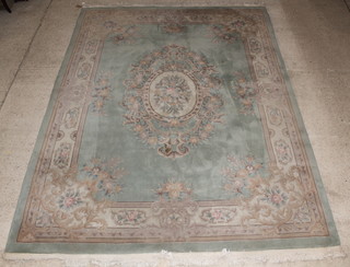 A green ground and floral patterned Chinese carpet 150" x 108", some light staining 