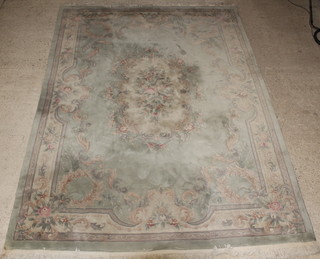 A Chinese green ground and floral patterned carpet 150" x 108", some slight staining 