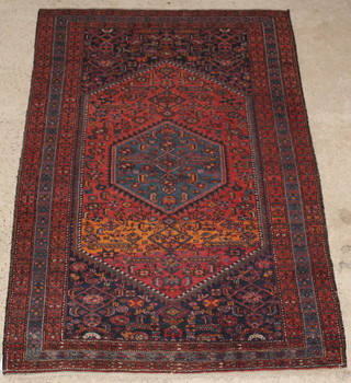 A Persian Nahavand red and blue ground rug, the central lozenge with lozenge shaped medallion 80" x 53"  
