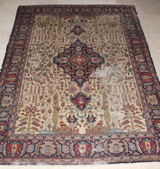 An Antique Tabriz  sand and blue ground tribal rug with central medallion within floral borders 153" x 110", in wear  
