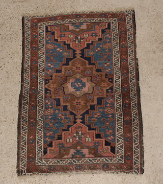 An Antique Persian Tafresh rug with blue and red ground and stylised diamonds to the centre 46" x 31" 