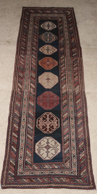 An Antique Caucasian  blue ground runner with 8 octagons to the centre, 153" x 46"