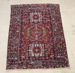 A Persian Karajeh red and blue ground rug 78" x 56" 