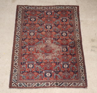 An Antique Persian Malayer brown ground rug 78" x 57", in wear 
