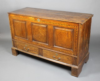 An 18th Century inlaid oak mule chest with panels to the front and brass escutcheon, the base fitted 2 drawers with brass swan neck drop handles, raised on square supports 36"h x 58"w x 23"d 