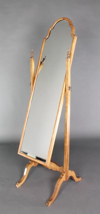 A Queen Anne style shaped plate cheval mirror contained in a walnut swing frame 61 1/2"h x 15 1/2"w 