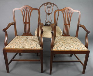 A pair of Hepplewhite style camel back carver chairs with upholstered drop in seats, raised on square tapering supports together with Hepplewhite style chair with shield shaped back 