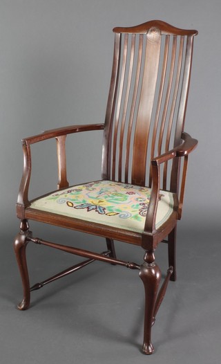 An Edwardian Art Nouveau inlaid mahogany stick and rail back carver chair with Berlin wool work seat, raised on cabriole supports with turned box stretcher 