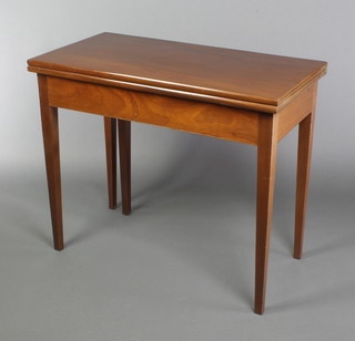 A Georgian style mahogany tea table, raised on square tapered supports 28 1/2"h x 34"w x 17"d 