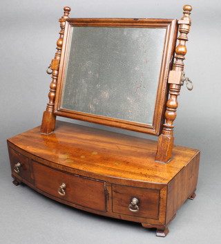 A 19th Century rectangular plate dressing table mirror contained in an associated mahogany frame, the bow front base fitted 1 long drawer flanked by 2 short drawers, raised on ogee bracket feet 16"h x 16 1/2"w x 8 1/2"d  