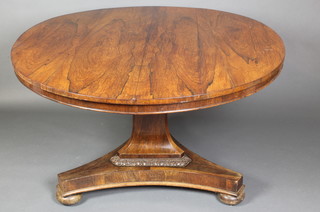 A Regency rosewood snap top breakfast table, raised on a chamfered column and triform base with bun feet 27"h x 46"w x 52"d 
