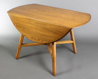 An Ercol light elm oval drop flap dining table raised on square supports with X framed stretcher 27 1/2"h x 44"w x 24"l when closed by 48" when extended, the base with label Design 377 BJHO 7094
