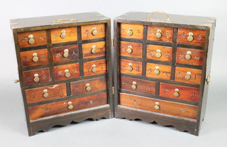 A Korean hardwood and brass banded medicine/spice chest, the interior fitted 18 short drawers, 4 intermediate drawers and 2 long drawers, when closed  15"h x 12"w x 13"h, when open 15"h x 26"w x 6 1/2"h  