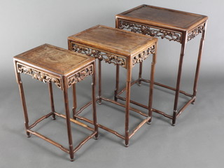 A nest of 3 Chinese hardwood rectangular interfitting coffee tables with carved fruit and leaf aprons, the tallest 28" x 20" x 15", the middle 25" x 18" x 13", the smallest 23"h x 16"w x 10 1/2"d 