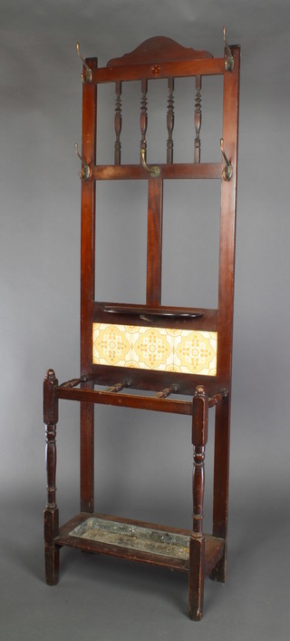 A Victorian mahogany hall stand with bobbin turned decoration, the tiled back complete with drip tray 71"h x 22"w x 10 1/2"d 