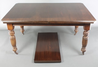 A Victorian mahogany extending dining table with 1 extra leaf, raised on turned and reeded supports 29"h x 41"w x 59"l x 77"l with extra leaf 
