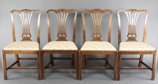 A set of 4 19th Century Hepplewhite style dining chairs with splat backs and upholstered seats raised on box framed stretchers 