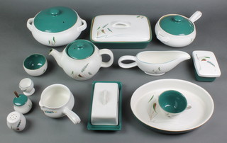 A Denby Green Wheat pattern oven proof tea and dinner service comprising 3 lidded dishes and covers, salt, pepper and mustard, 7 egg cups, 2 oval casseroles, 5 graduated jugs, 17 coffee cups, 6 mugs, 1 large teapot, 1 small teapot, 2 lidded casseroles, 2 casseroles with handles, a butter dish and lid, 8 small soup bowls, 24 saucers, 12 small dessert bowls, 5 small odd bowls, 2 large saucers, 7 large dessert bowls, 12 small plates, 15 medium plates, 18 large plates, fruit bowl, salad bowl, 2 pots, 4 small sauce boats, an oval dish, 3 vegetable dishes and covers, 2 large sauce boats, 2 oval dishes, 2 rectangular meat plates, 6 odd lids, 2 circular dishes and a rectangular dish    