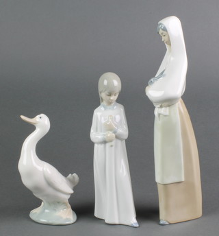 A Nao figure of a lady holding a rabbit 10 1/2", a ditto of a girl in nightwear 8" and another of a standing goose 6" 