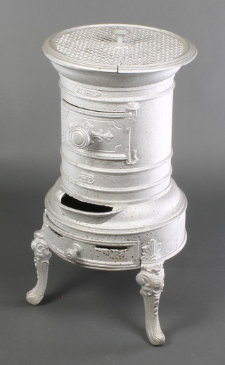 A Rosieres French cylindrical cast iron solid fuel stove, raised on cabriole supports 28 1/2"h x 15" diam.  