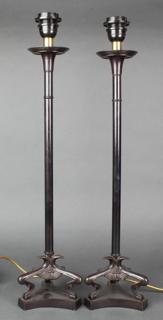 A pair of Regency style bronze table lamps with cabriole legs raised on triform bases, 22"h 