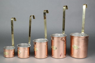 A set of 5 graduated Continental copper and brass milk measures 1L, 0.75l, 0.50l, 0.25l, 0.10l