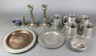 An 18th Century pewter plate 9" with hole, an Indian pewter plate 12", 2 19th Century pewter candlesticks with ejectors 9", some corrosion to the candlesticks, 5 pewter tankards etc 
