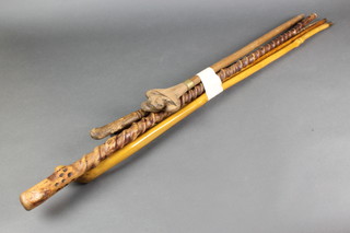 A walking stick, the handle in the form of a pair of seated lions together with 4 other sticks 