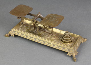 A pair of 19th Century gilt metal postal scales raised on a rectangular base with hoof supports, complete with weights 
