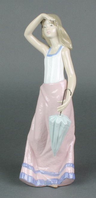 A Nao figure of a young lady holding a parasol  12" 