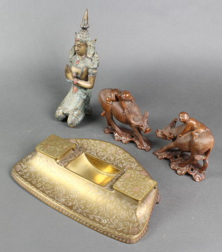 A Burmese bronze figure of a kneeling figure 9", a Benares brass rectangular inkwell (missing bottles), 2 carved wooden figures of buffalos with attendants 4 1/2" 