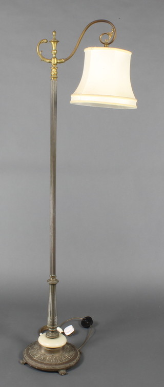 A standard lamp with reeded column raised on an embossed brass and onyx base 