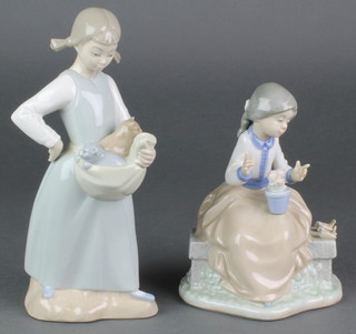 A Nao figure of a girl sitting on a wall beside 2 birds 7" and a ditto of a girl with kittens in her apron 9" 