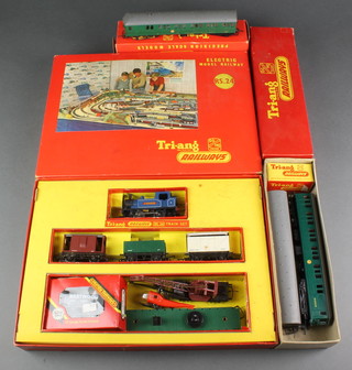 A Triang RS.24 electric train set, boxed, (box damaged), a Triang R156 Suburban motor coach boxed and 2 garages boxed