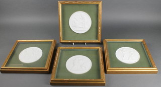 A set of 4 white bisque circular plaques depicting classical figures, framed 5 1/2" 
