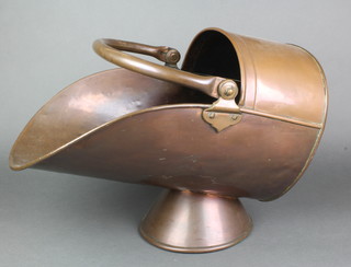 A Victorian copper helmet shaped coal scuttle
