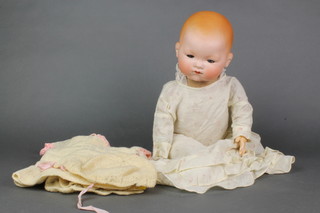 Armand Marseille, a German porcelain headed doll with sleeping eyes and closed mouth, head incised AM Germany 534118 