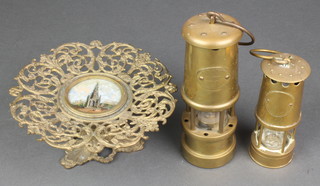 2 brass reproduction miner's safety lamps 7" and 5" and a pierced gilt metal tazza the centre decorated a Scots memorial 7" 
